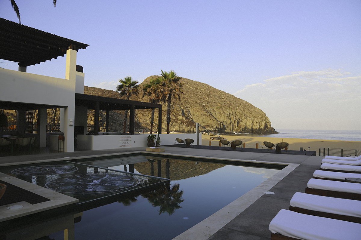 The pool with the ocean and mountain in the distance at Hotel San Cristóbal in Todos Santos, Baja California Sur, Mexico.
