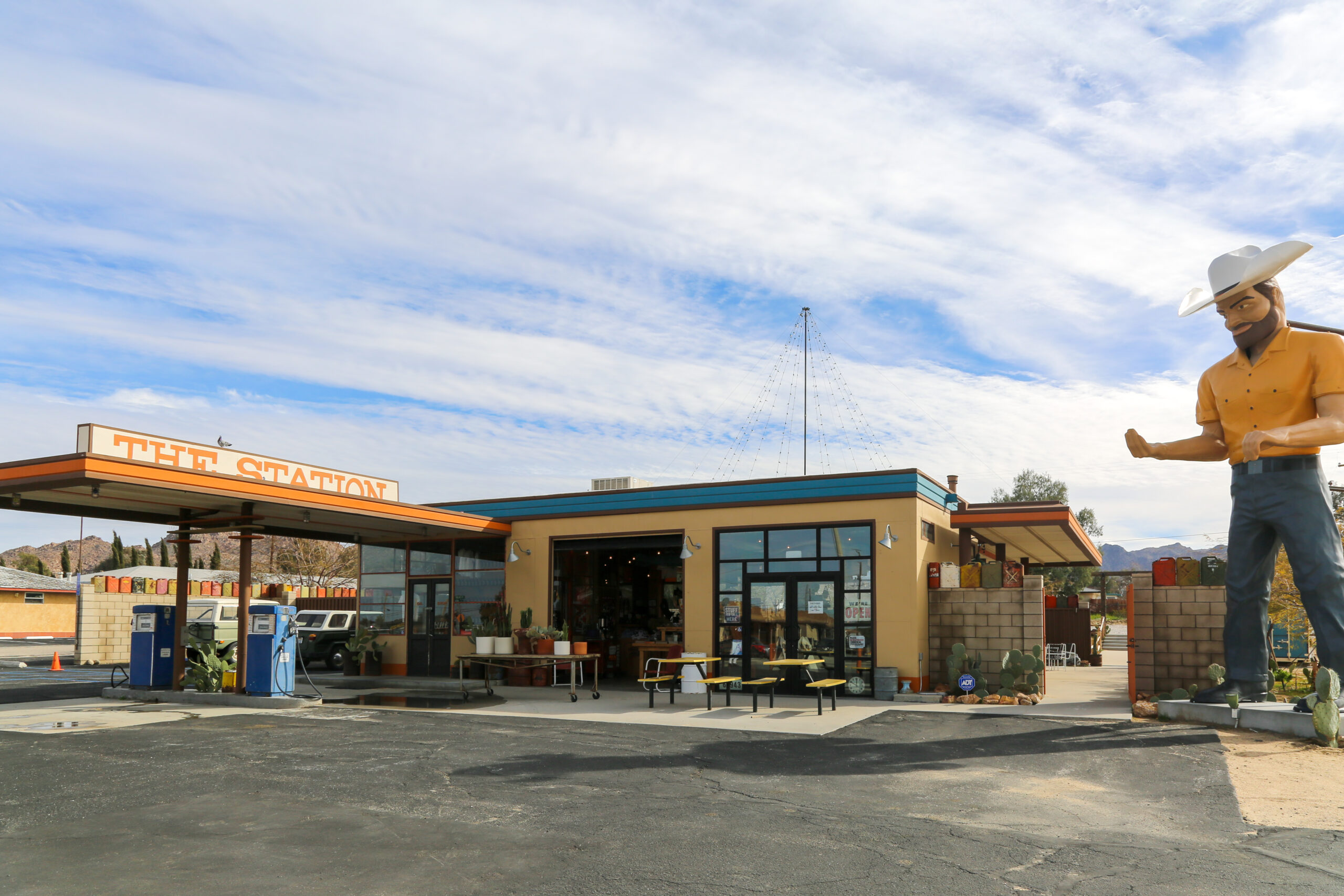 Exterior view of a former gas station renovated into a quirky gift shop called The Station in Joshua Tree, California.