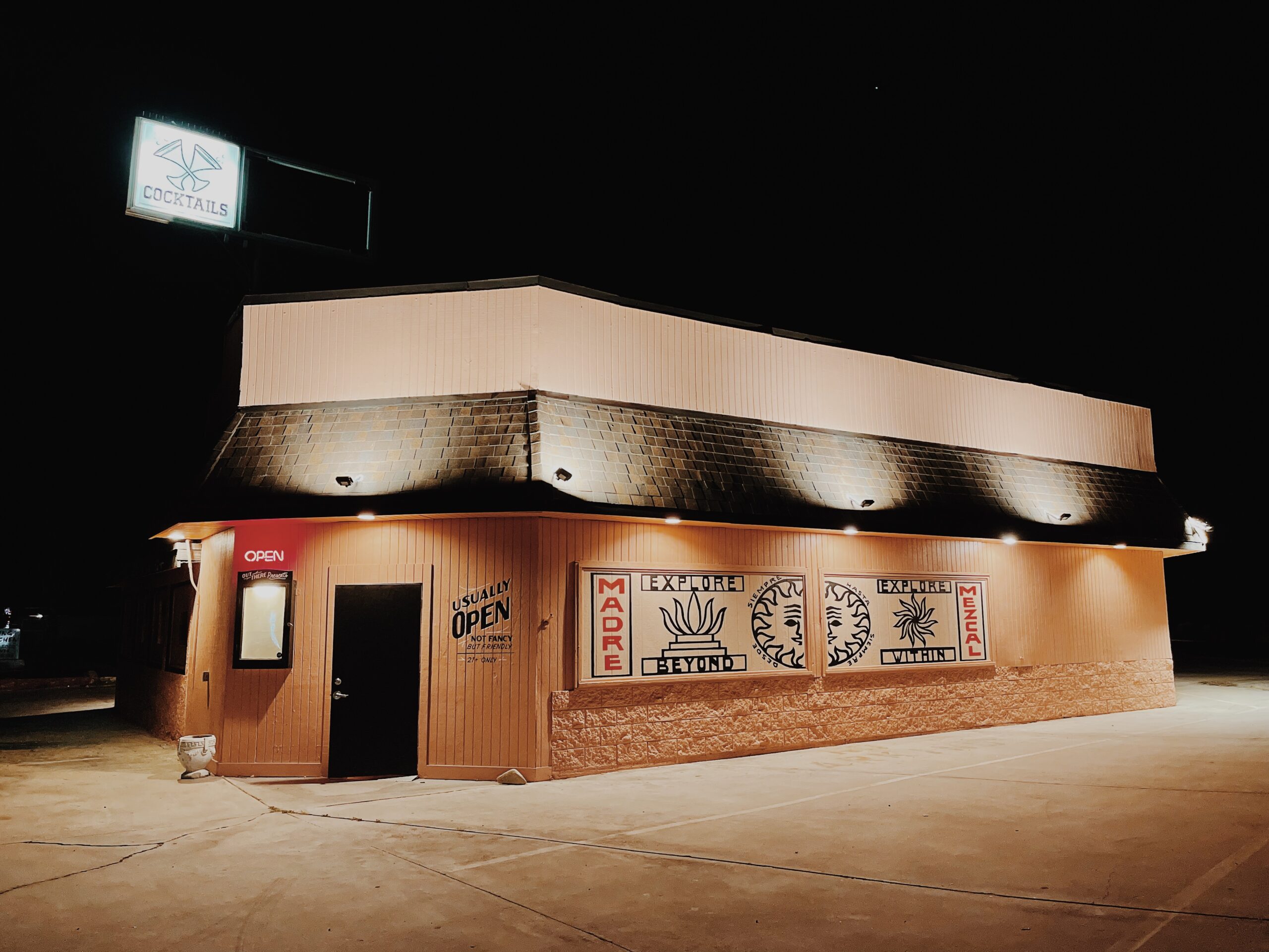 Exterior night time view of Out There Bar located in Twentynine Palms, California.