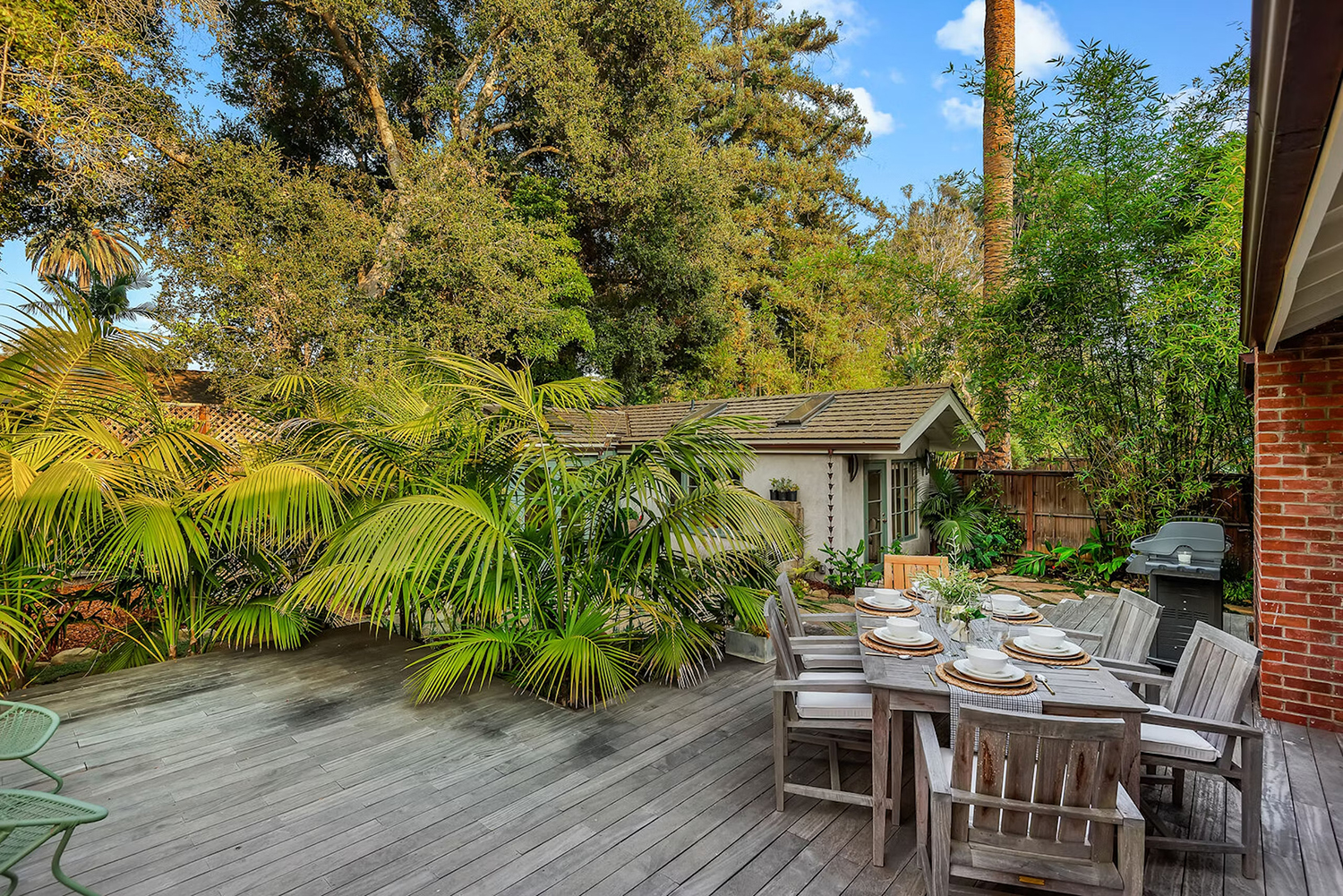 Patio and wooden deck with much greenery at Montecito California vacation rental home called California Iris.