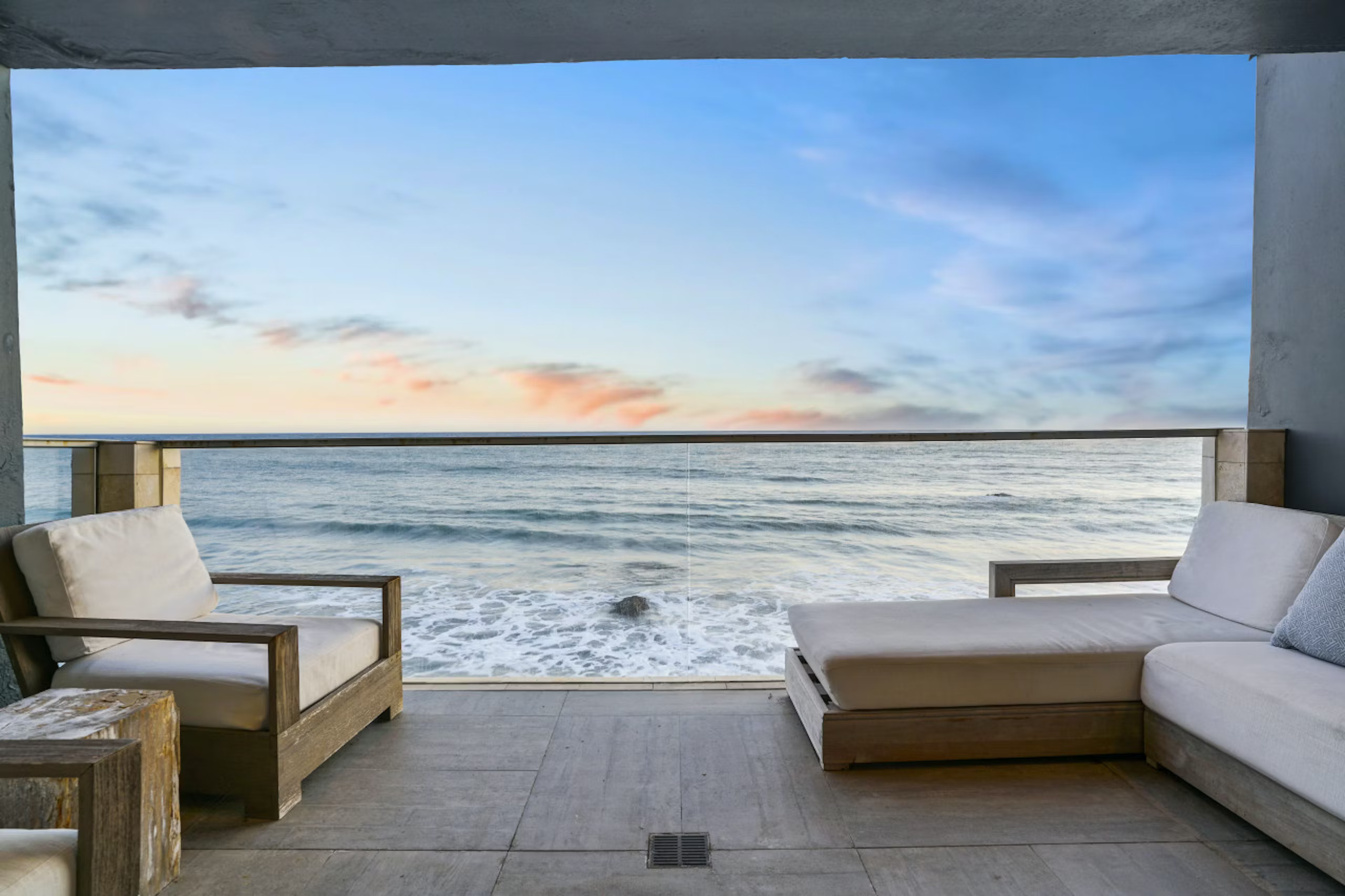 Pacific Ocean view with lounging furniture at coastal California vacation home rental in Malibu called Ocean Playlist.