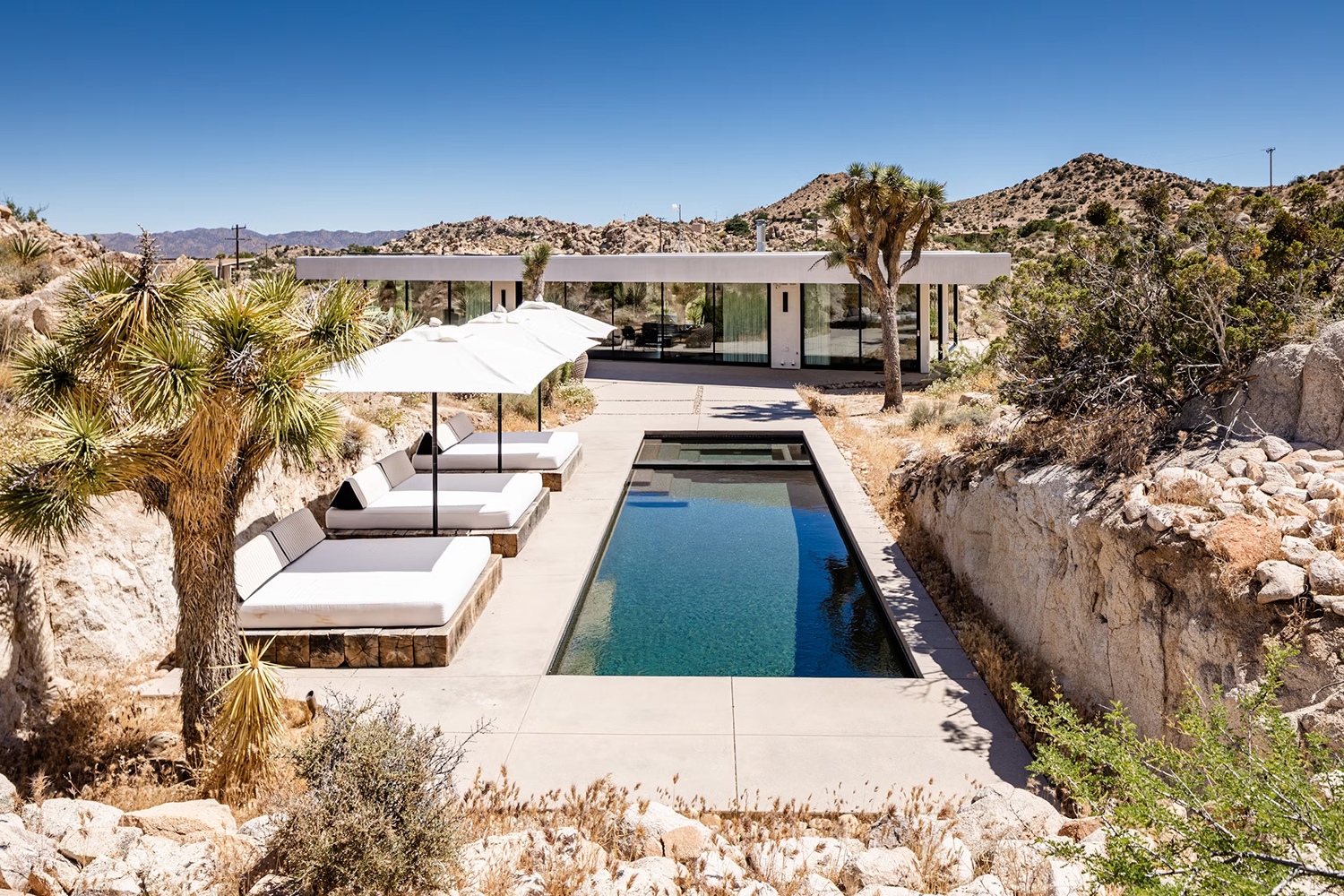 View of the pool and lounge area at Desert Skies vacation home rental near Joshua Tree National Park, California.