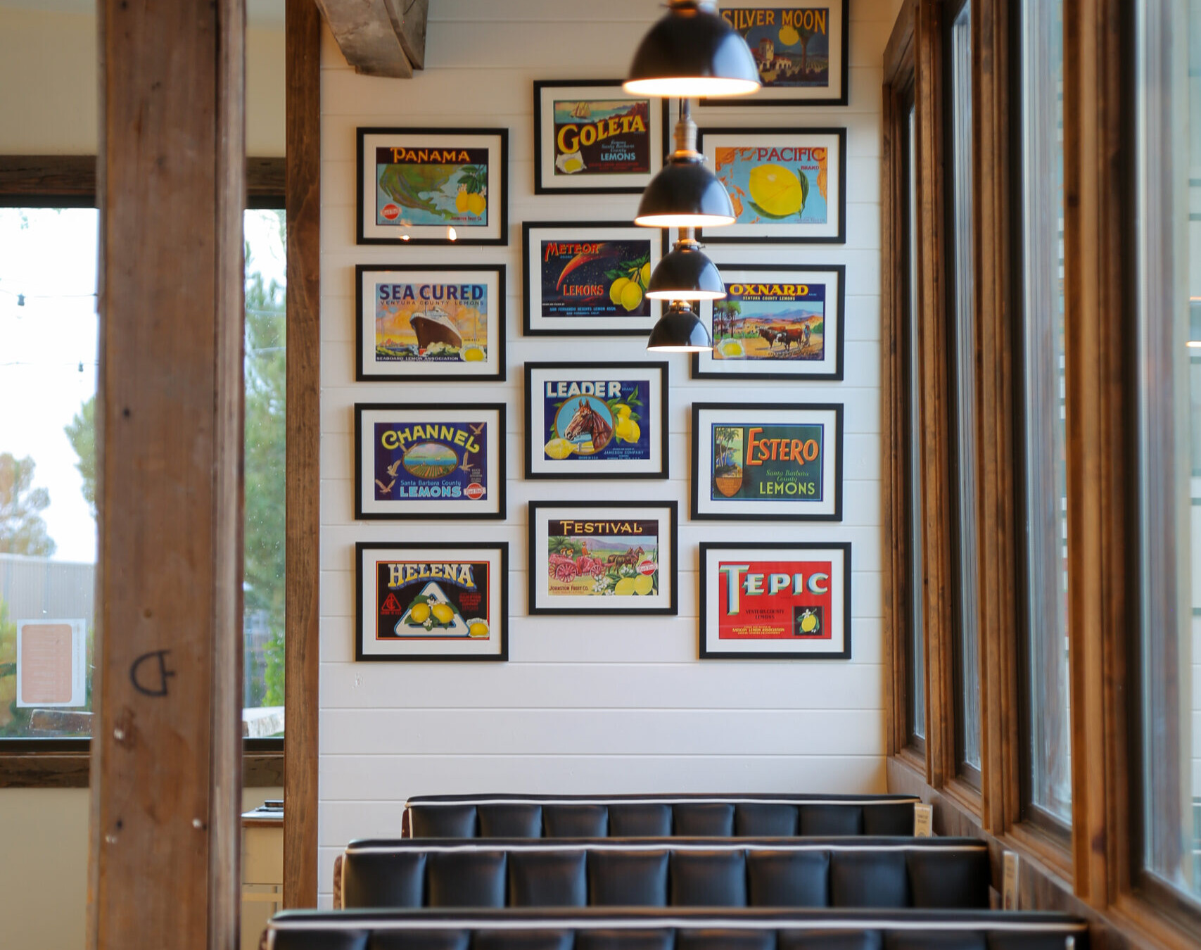 View of booths in the Cuyama Buckhorn diner with vintage graphic art displayed on the far wall located in New Cuyama, California.