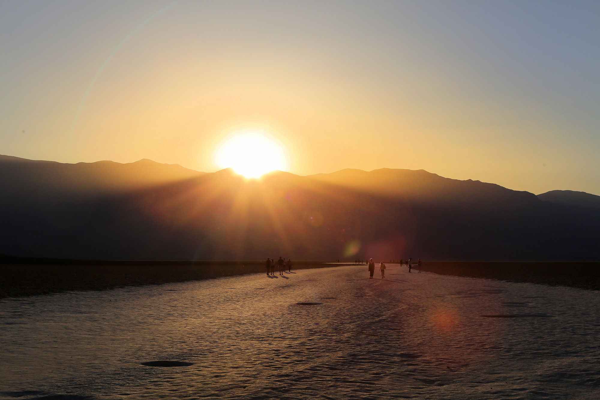 Sunset against the mountains at Badwater Basin in Death Valley National Park.