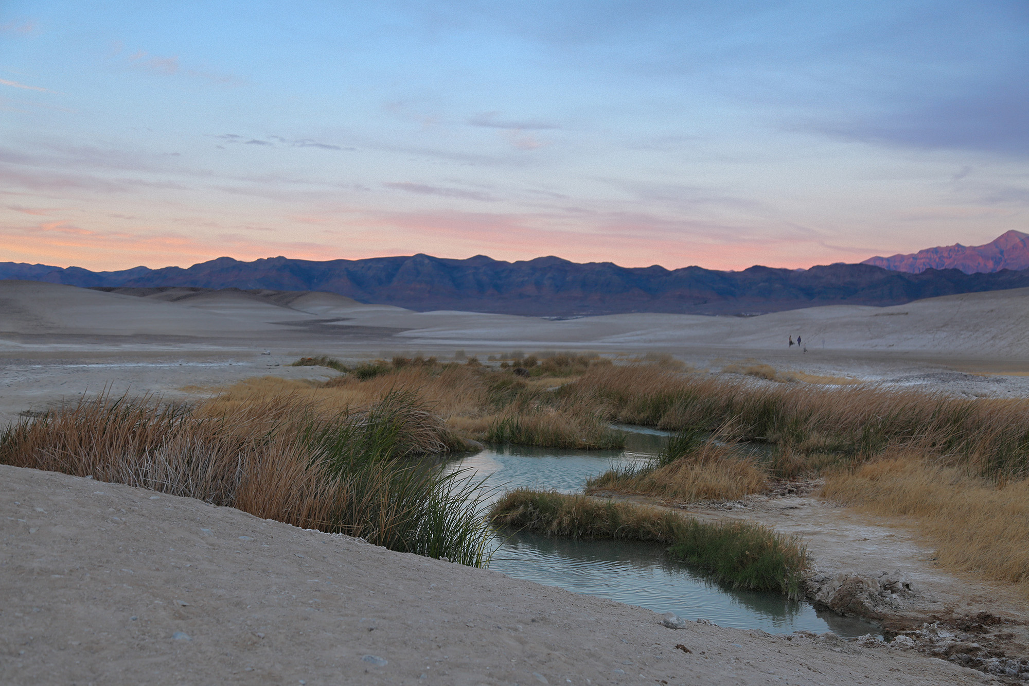 The Tecopa Natural Hot Springs at sunset with mountains in the background near Death Valley National Park.