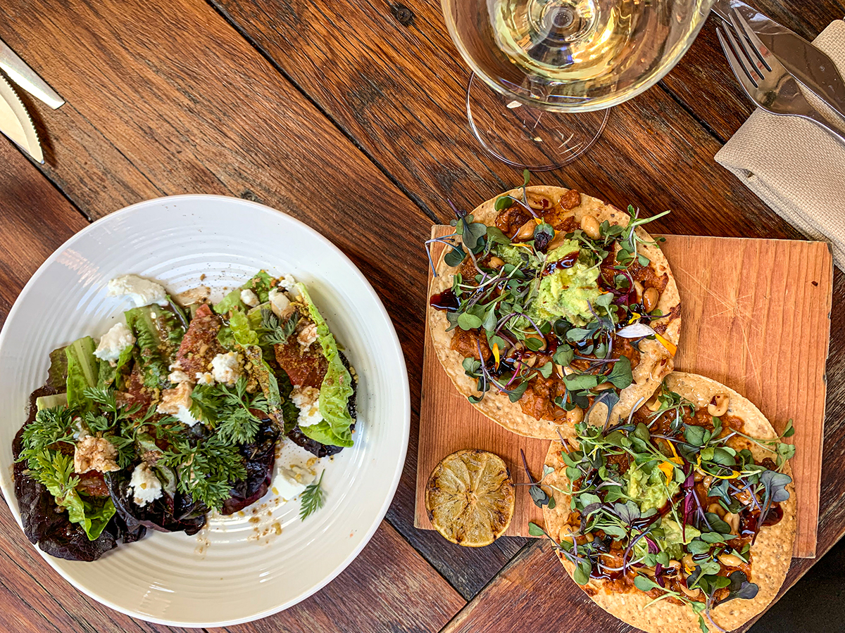 Uni tostada, a vibrant salad and a glass of white wine at Pico in Los Alamos, California.