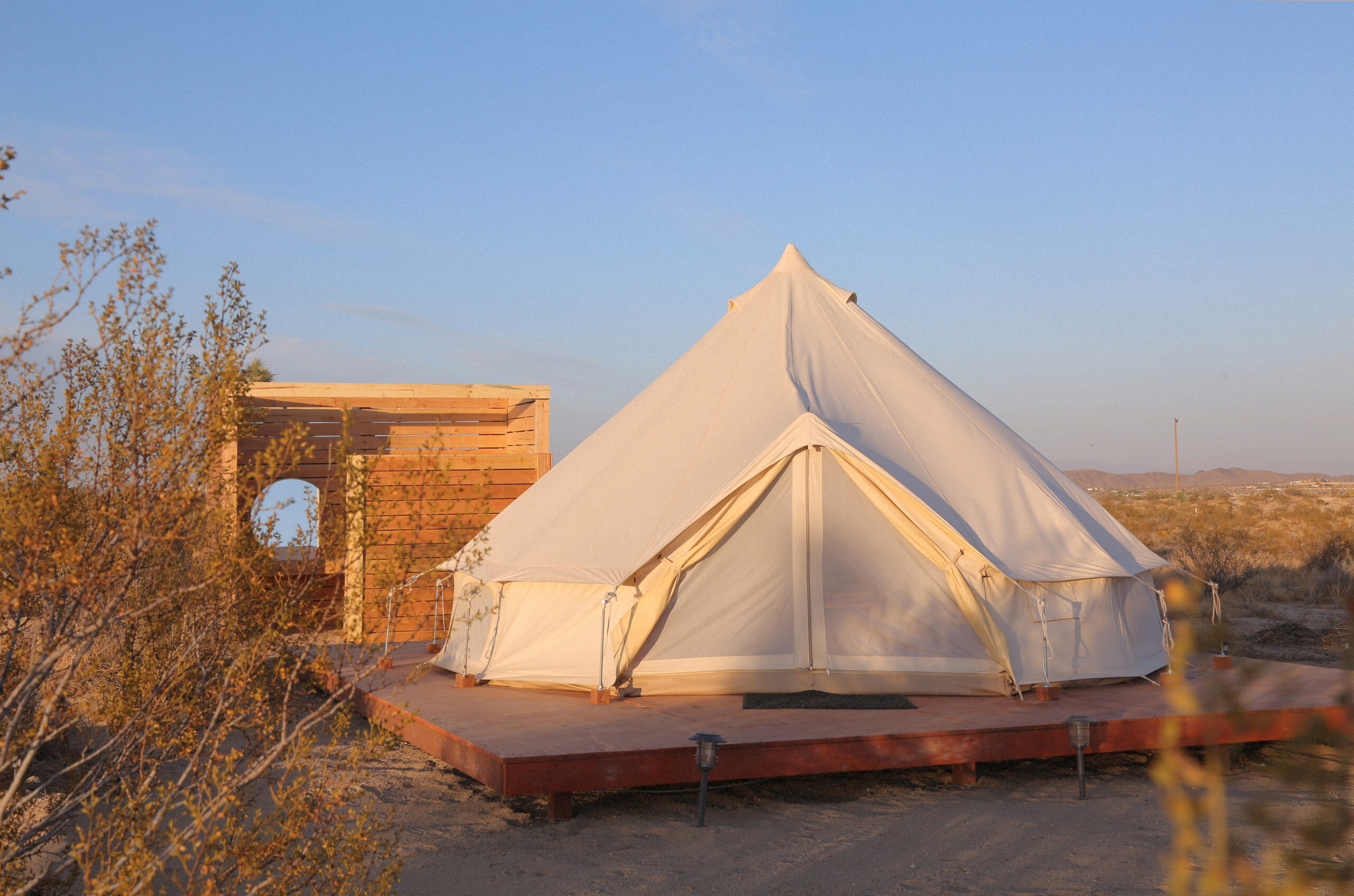 White glamping tent at Desert Sky Escapes near Joshua Tree National Park, California.