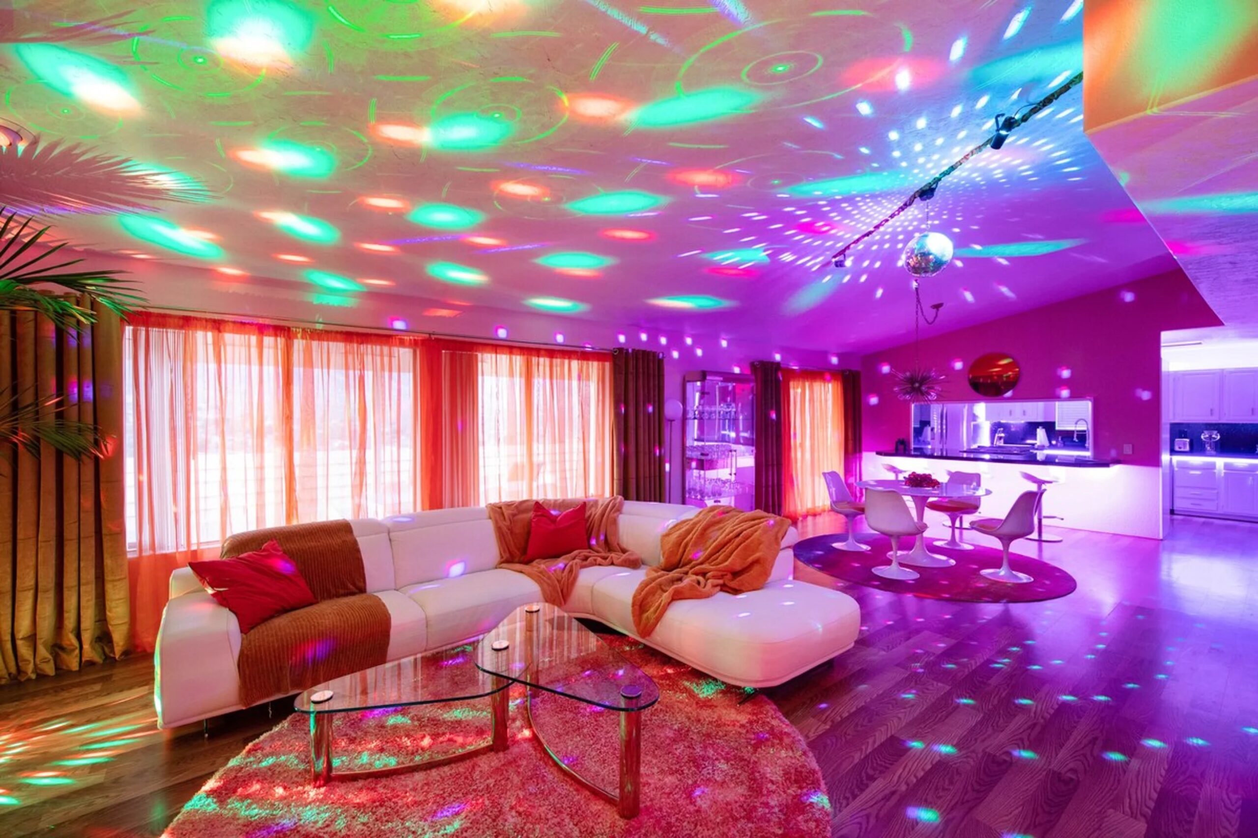 Interior view of a Disco Daydream retro themed home with party lights illuminating the room near Joshua Tree National Park, California.