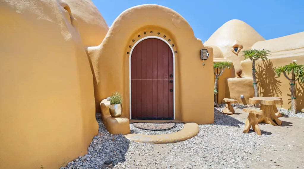 Sand colored oddity vacation rental home called The Desert Firmament in San Bernadino County, California.