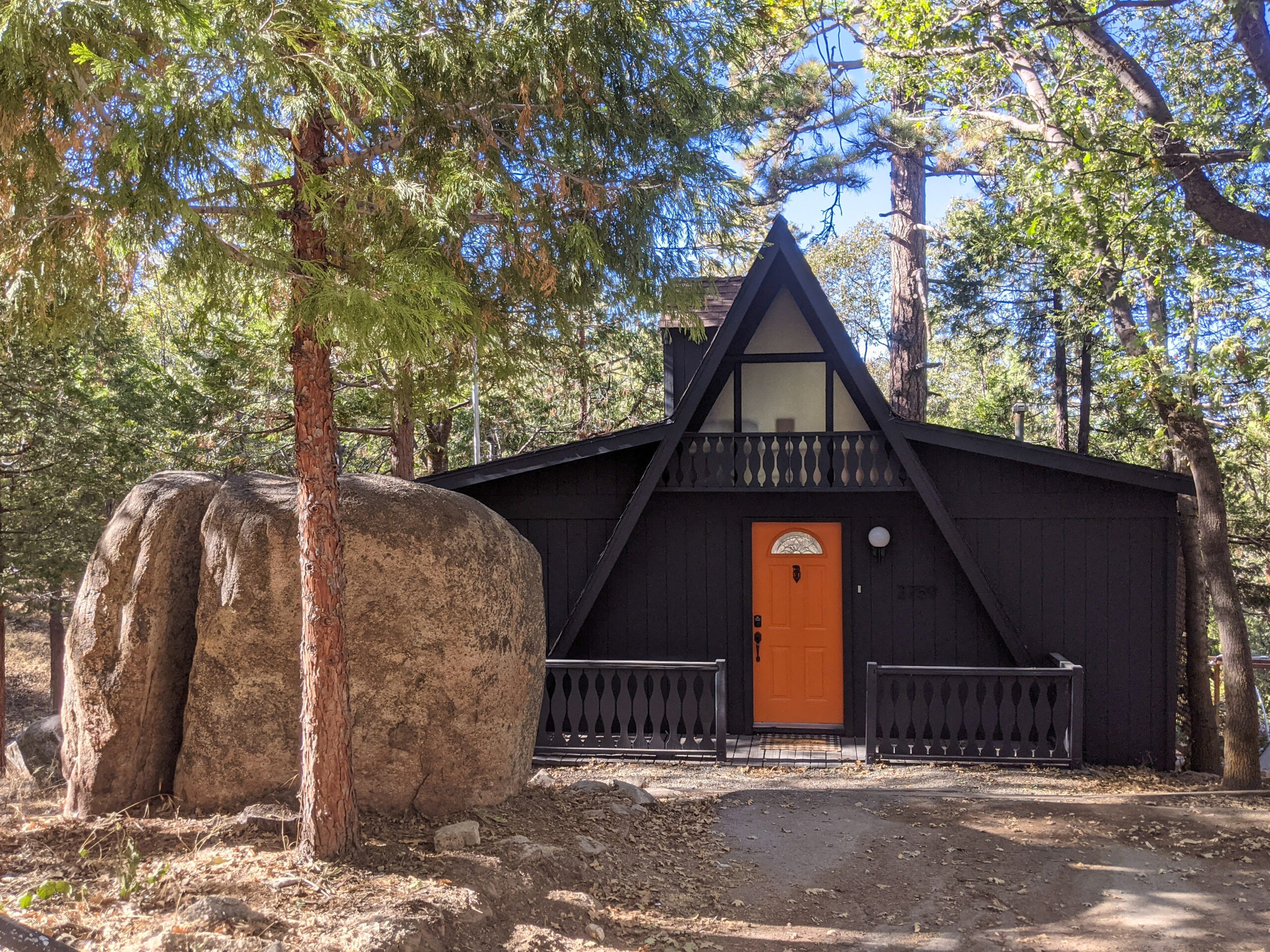 Exterior view of The Hideout at Split Rock A-frame cabin vacation rental near Lake Arrowhead, California.