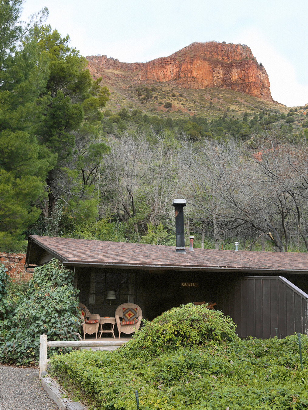 Exterior of a cabin rental tucked into a forested area at the Briar Patch Inn in Sedona, Arizona.