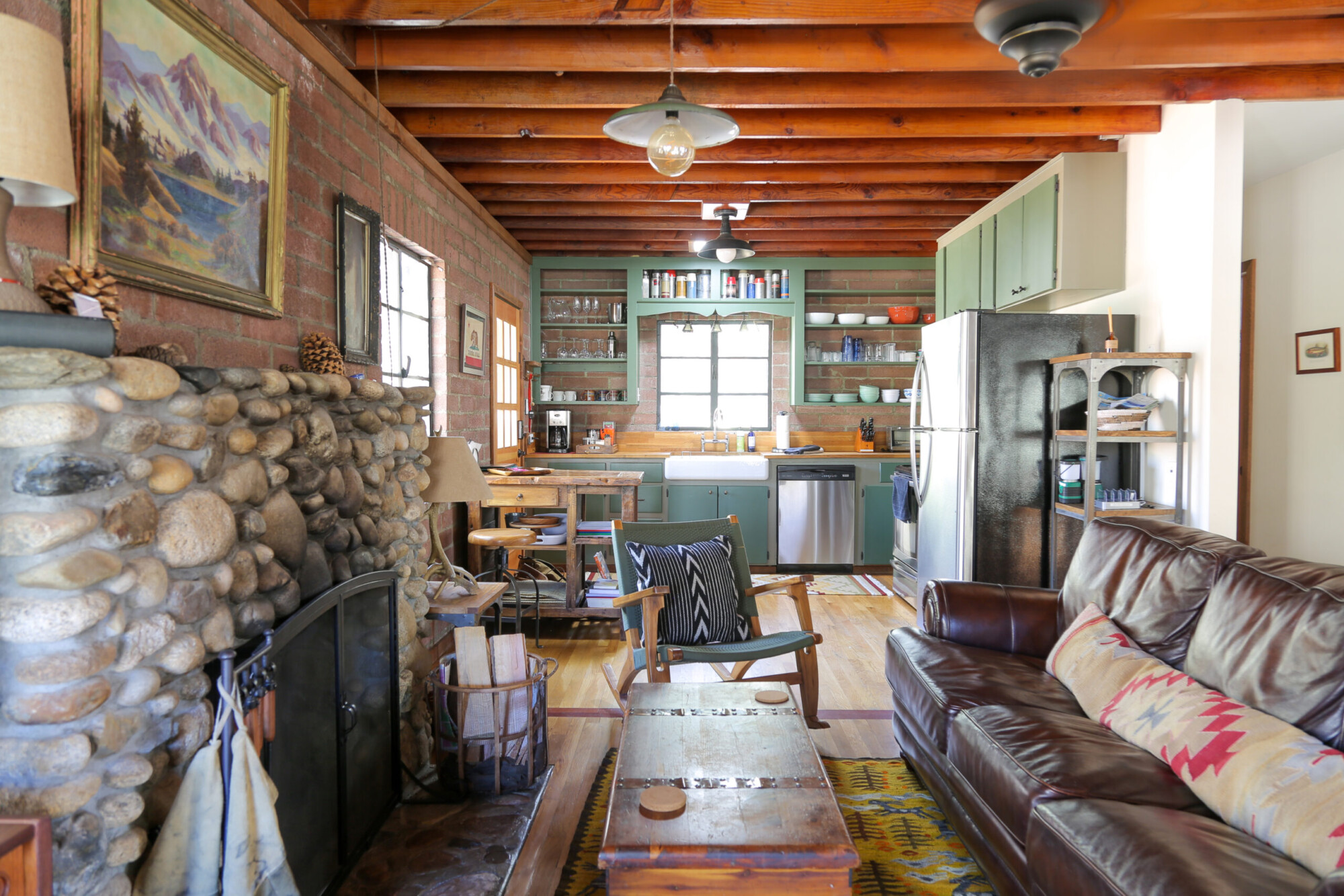 View of the cozy living room and kitchen at Kern River House's River Willow Cabin in Kernville, California.