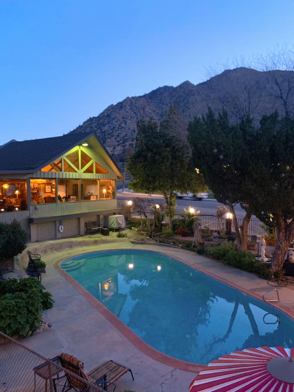 Birds eye view of the pool at dusk at a motel called Piazza's Pine Cone Inn in Kernville, California.