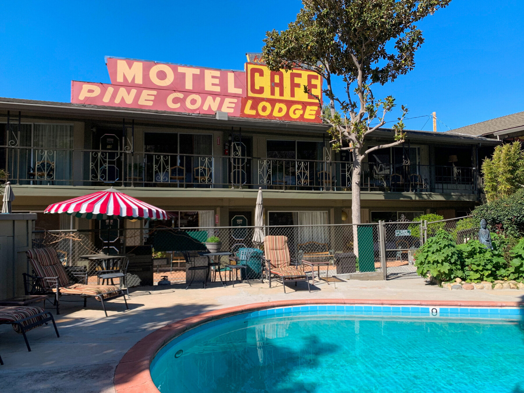 Poolside view of small motel called Piazza's Pine Cone Inn in Kernville, California.