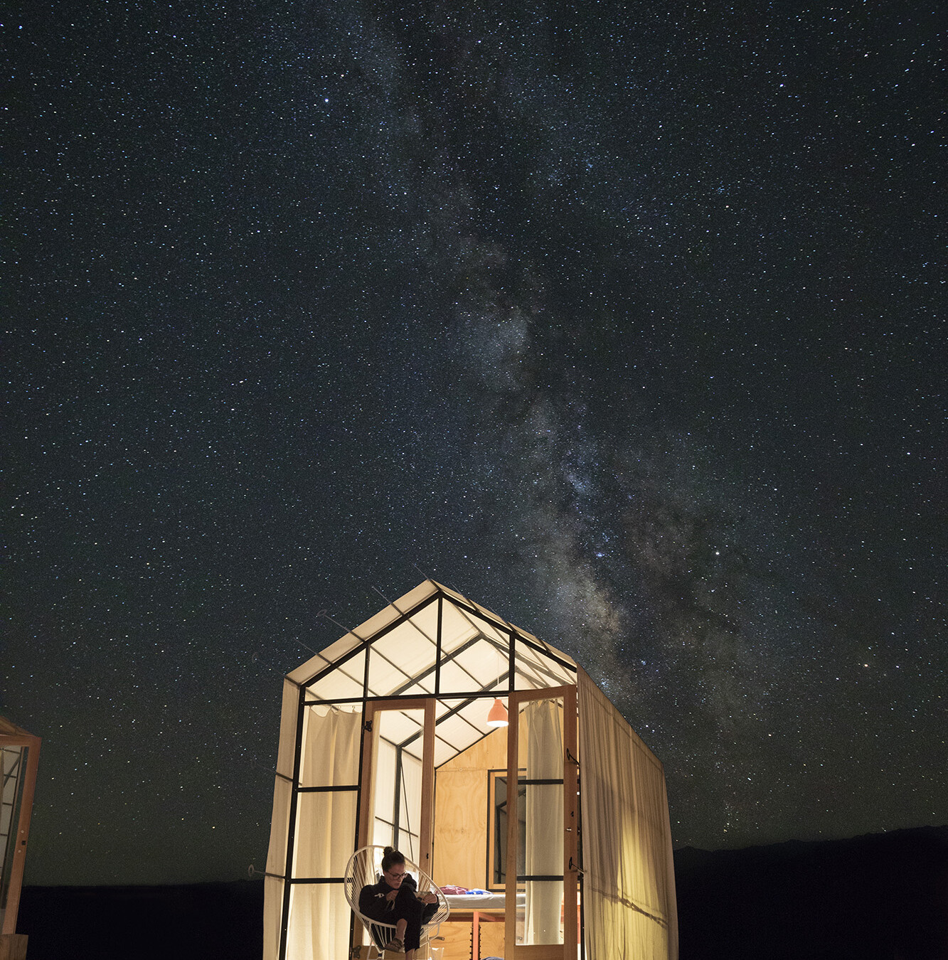 Night time photo of a glamping structure at Blue Sky Center in New Cuyama, California.
